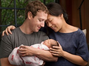 Max Chan Zuckerberg is held by her parents, Mark Zuckerberg and Priscilla Chan Zuckerberg