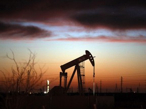 An oil pumpjack works at dawn in the Permian Basin oil field on January 20, 2016 in the oil town of Andrews, Texas.