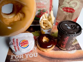 Restaurant Brands International, owner of the Tim Hortons and Burger King chains, reported a huge leap in profit help along by cost cutting.