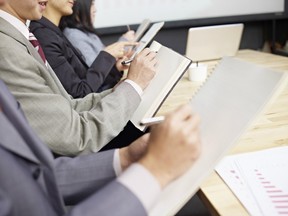 business people taking notes during meeting.