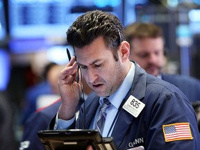 Traders work on the floor of the New York Stock Exchange