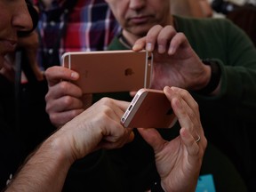 Attendees view the new Apple Inc. iPhone SE smartphone after an event in Cupertino, California, U.S., on Monday, March 21, 2016.