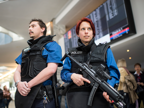 Police officers  stand guard  at he airport in Zurich,  Switzerland, Tuesday. All flights to Brussels are cancelled and security measures have been raised following the  attacks at Brussels airport and on the metro system.