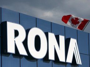 A Canadian flag flies over Rona Inc. signage displayed at the company's store in Toronto.