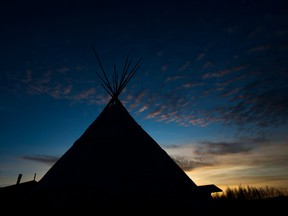 A teepee is silhouetted in the northern Ontario First Nations reserve of Attawapiskat, Ont.