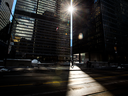 A pedestrian walks in the heart of Toronto's financial district at Bay and King streets. 