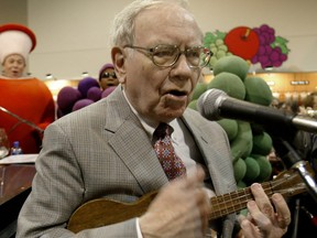 Berkshire Hathaway CEO Warren Buffett performs with the Fruit of the Loom guys at a previous shareholders' meeting.