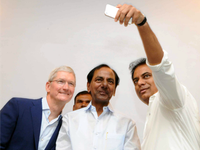 Apple chief executive Tim Cook (L), Telangana chief minister K. Chandrashekar Rao (C) and state IT minister KT Rama Rao (R) taking a selfie photograph as they inaugurated a new Apple development centre in Hyderabad.