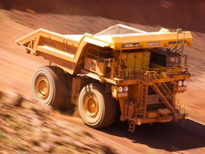 An autonomous haul truck drives through a pit of the Rio Tinto West Angelas iron ore mine in Australia.