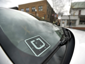 Uber decal is displayed in the window of a car.