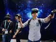 Visitors trying wearable virtual reality devices during the first day of the Consumer Electronics Show (CES) in Asia in Shanghai.
