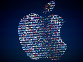 The Apple logo is shown on a screen at the Apple Worldwide Developers Conference in the Bill Graham Civic Auditorium, San Francisco.