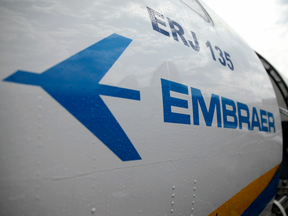 A logo sits on the fuselage of an Embraer SA ERJ-135.