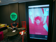 A Spotify Ltd. logo sits on display as an employee uses a laptop computer in a work area inside the music streaming company's offices in Berlin, Germany