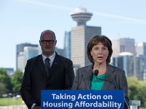 British Columbia Finance Minister Michael de Jong, left, looks on as Premier Christy Clark makes an announcement during a news conference in Vancouver, B.C., Wednesday, June, 29, 2016. Foreign nationals who buy real estate in Metro Vancouver will pay an additional property transfer tax of 15 per cent starting Aug. 2.