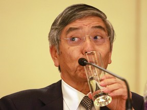 Governor of the Bank of Japan Haruhiko Kuroda, sips from a glass during a press conference held at the close of the G20 Finance Ministers and Central Bank Governors meeting in Chengdu, China.