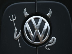 A Volkswagen logo adorned with horns, a pitchfork and a tail and in the guise of a devil decorates a Volkswagen passenger van on November 10, 2015 in Berlin, Germany.