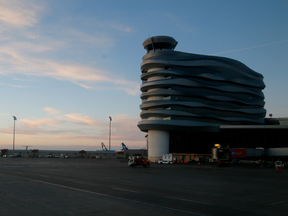 The setting sun illuminates the eight-storey Central Tower with the NAV Canada Control Tower atop in Edmonton, Alberta.