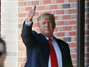 Republican presidential candidate Donald Trump gives a thumbs-up as he leaves the residence of Indiana Gov. Mike Pence