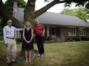Dave, Debbie and Ken Dryden (left to right) in front of the family home, which serves as the headquarters for the Sleeping Children Around the World charity.