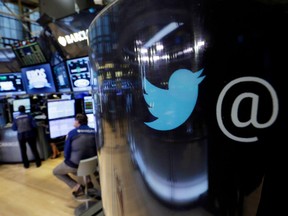 The Twitter logo appears on a phone post on the floor of the New York Stock Exchange