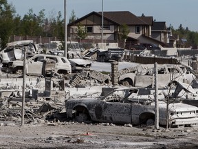 Burned-out homes and vehicles in fire-ravaged Fort McMurray, Alberta.