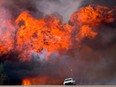 Wildfires raging through Alberta spread to the main oil-sands facilities north of Fort McMurray, knocking out an estimated 1 million barrels of production from Canada's energy hub.