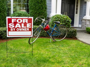 Closeup view of Modern Suburban Home with for Sale Real Estate Sign