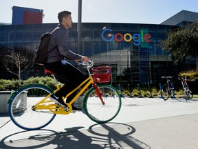 A cyclist rides past Google Inc. offices inside the Googleplex headquarters in Mountain View, California