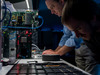 Rodrigo Alverez, system engineer for International Business Machines Corp. (IBM), left, tests new SyNAPSE chips at the IBM Almaden Research Center in San Jose, California