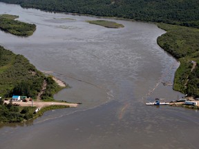 Crews work to clean up an oil spill on the North Saskatchewan river near Maidstone after between 200,000 and 250,000 litres of crude oil and other material leaked into the river on Thursday from a Husky Energy pipeline.