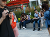 People using their smartphones outside of the CN Tower in Toronto, Ont.