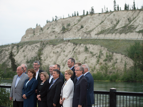 Canada's Premiers pose for a family photo alongside the Yukon River during a meeting of Premiers in Whitehorse, Yukon