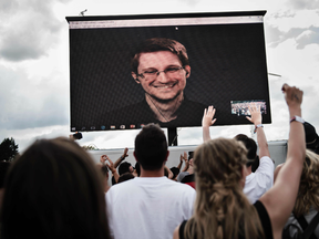 Former US intelligence contractor and whistle blower Edward Snowden can be seen on a giant screen as he is interviewed by the the performance group The Yes Men live at the Roskilde Festival in Denmark
