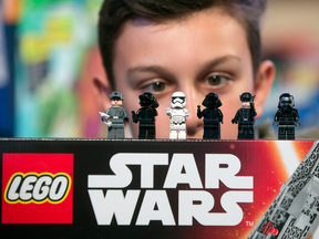 A child looks at Lego figurines from the Star Wars 'Kylo Ren's Command Shuttle', manufactured by Lego A/S
