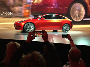 Tesla Motors unveils the lower-priced Model 3 sedan at the Tesla Motors design studio on March 31, 2016.