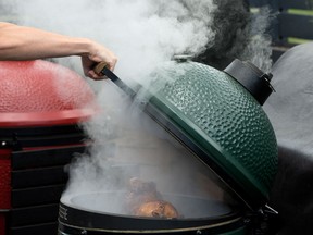 Urban Bonfire cooks up a feast — whole chickens, wings, pizzas and steaks — on two egg-shaped kamado-style charcoal ceramic grills during a demonstration for new owners of the grills.