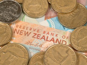 New Zealand's dollar surged to a one-year high after the country's central bank cut interest rates and signaled a more gradual easing path than some investors had anticipated.