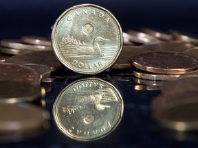 The Canadian dollar was trading at 77.71 cents about an hour after U.S. housing, inflation and manufacturing reports were released in Washington, D.C., and Statistics Canada issued manufacturing data that was slightly above estimates.