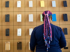 An Apple employee works on a display at a new Apple Store in Brooklyn's Williamsburg section in New York