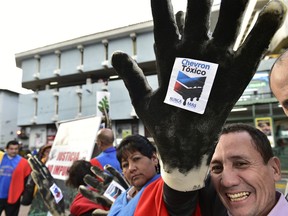 Activists protest against US multinational energy corporation Chevron at a square in Quito
