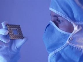 Technician holding microprocessor