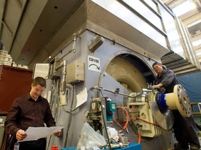 Fitters, testers and engineers inspect a 28 megawatt Synchronous generator at GE Canada in Peterborough.
