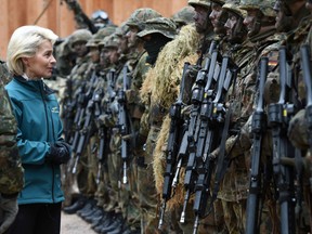 German Minister of Defense Ursula von der Leyen (C) posing with mountain infantry soldiers of the mountain infantry brigade 23.