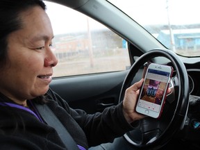 Iqaluit Mayor Madeleine Redfern opens Facebook to show a pair of kamiks on a local auction group in Iqaluit, Nunavut.