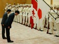 Canada's Prime Minister Justin Trudeau bows with Japan's Prime Minister Shinzo Abe (left) as they review a guard of honour before their meeting at Abe's official residence in Tokyo.