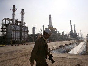An Iranian oil worker makes his way through Tehran's oil refinery south of the capital.