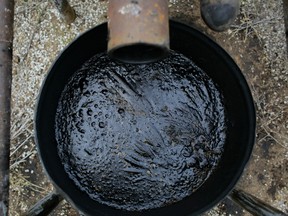 An overflow barrel holds oil