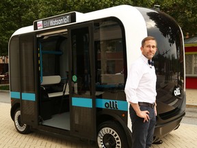 Local Motors CEO and co-founder John B. Rogers stands next to  Olli, a 3D-printed, self-driving, electric vehicle that can use the cognitive computing abilities of IBM’s Watson, best known for winning the game show Jeopardy!