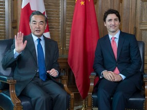 Prime Minister Justin Trudeau, right, meets with Chinese Foreign Minister Wang Yi on Parliament Hill